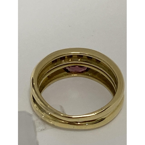 79 - 18ct yellow gold double band ring with diamonds set into both bands with central pink oval stone. Ap... 