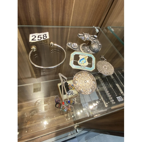 258 - Six items: Bermuda Sterling and enamel brooch, a Mondial BRM bangle, a Kelt brooch, a Sezgin 925 zod... 