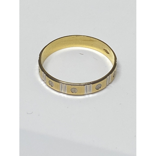 100 - White and yellow gold band ring with screw head design, approx size V, stamped 750, approx 2g