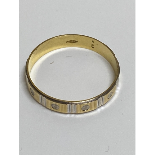 100 - White and yellow gold band ring with screw head design, approx size V, stamped 750, approx 2g