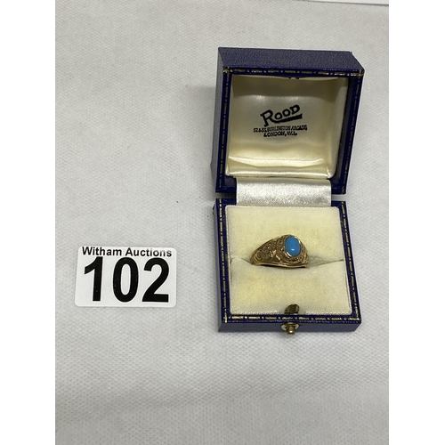 102 - A 9ct yellow gold ring Turquoise stone with  London University and tragedy mask detailing to mount, ... 