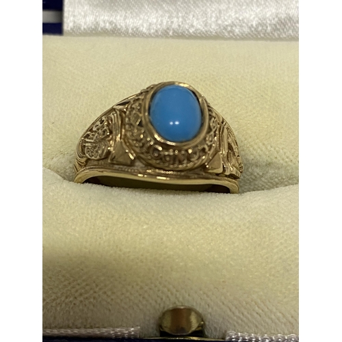 102 - A 9ct yellow gold ring Turquoise stone with  London University and tragedy mask detailing to mount, ... 