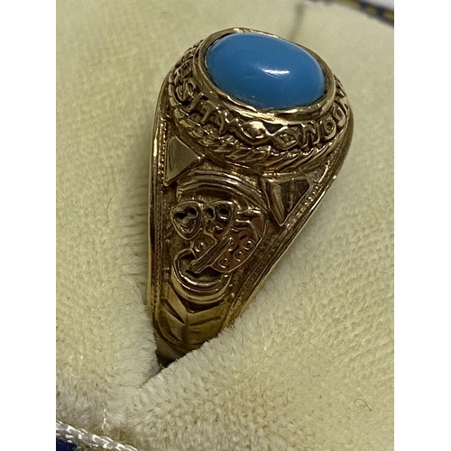 102 - A 9ct yellow gold ring Turquoise stone with  London University and tragedy mask detailing to mount, ... 