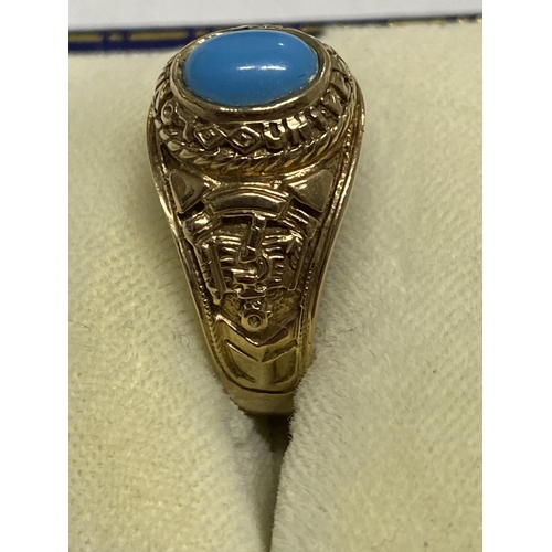 102 - A 9ct yellow gold ring Turquoise stone with  London University and tragedy mask detailing to mount, ... 