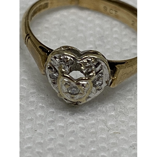 104 - A 9ct yellow gold heart shaped ring, outer layer of diamonds with raised central stone in heart shap... 