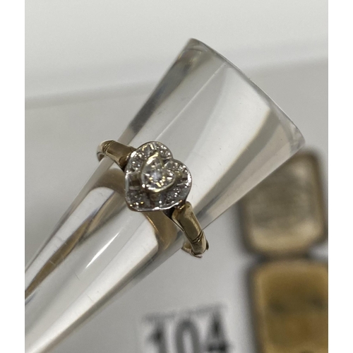 104 - A 9ct yellow gold heart shaped ring, outer layer of diamonds with raised central stone in heart shap... 