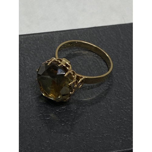 97 - 9ct gold yellow gemstone ring set in raised claw setting, approx size L, hallmarked London 375