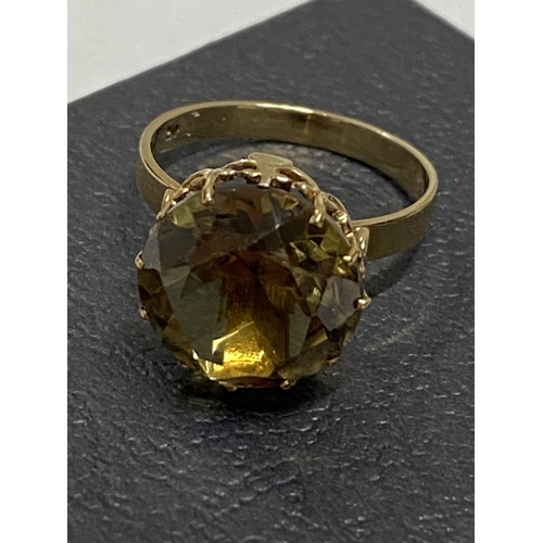 97 - 9ct gold yellow gemstone ring set in raised claw setting, approx size L, hallmarked London 375