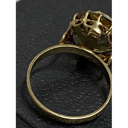 97 - 9ct gold yellow gemstone ring set in raised claw setting, approx size L, hallmarked London 375