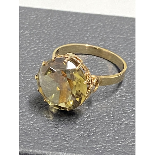 97 - 9ct gold yellow gemstone ring set in raised claw setting, approx size L, hallmarked London 375