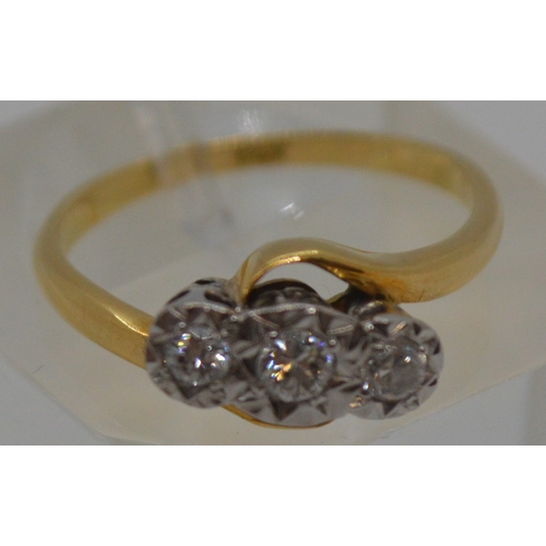 87 - 18ct yellow gold tri-stone diamond ring in  a cross over design setting, marked 18CT, approx 0.20CT,... 