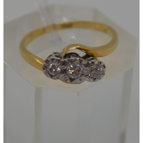 87 - 18ct yellow gold tri-stone diamond ring in  a cross over design setting, marked 18CT, approx 0.20CT,... 