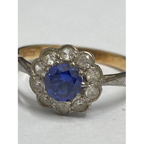 92 - Yellow gold ring 9ct gold ring with central blue stone (poss sapphire) and clear stones, hallmarked ... 