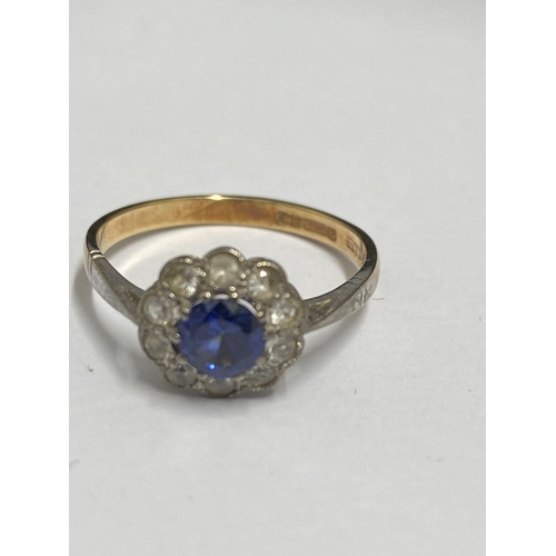 92 - Yellow gold ring 9ct gold ring with central blue stone (poss sapphire) and clear stones, hallmarked ... 