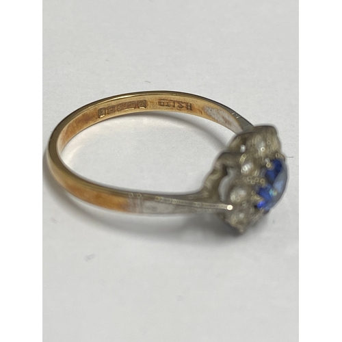 92 - Yellow gold ring 9ct gold ring with central blue stone (poss sapphire) and clear stones, hallmarked ... 