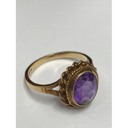 91 - 9ct gold ring set with central amethyst oval stone, hallmarked Birmingham, approx size o