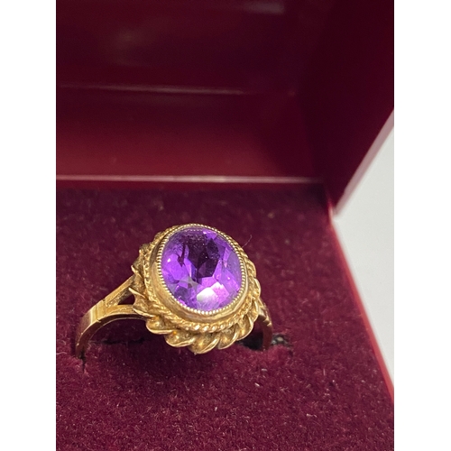 91 - 9ct gold ring set with central amethyst oval stone, hallmarked Birmingham, approx size o