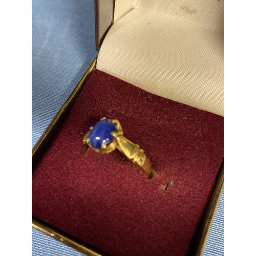 119 - 18ct yellow gold ring with claw setting encapsulating oval semi precious blue stone, approx size M, ... 