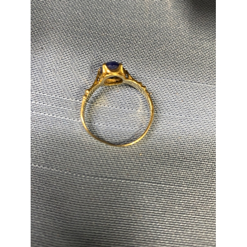 119 - 18ct yellow gold ring with claw setting encapsulating oval semi precious blue stone, approx size M, ... 