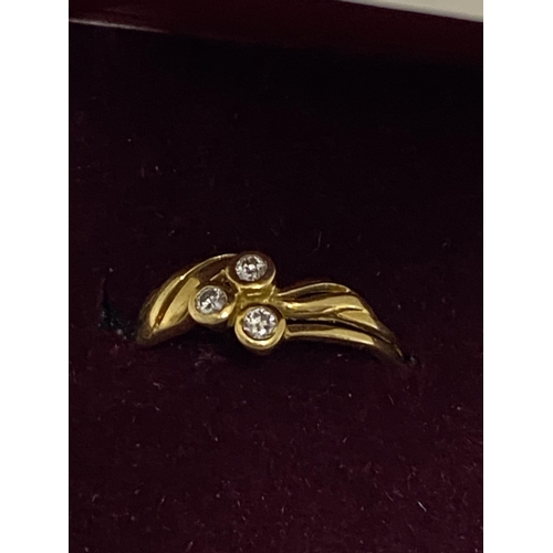 125 - 18ct yellow gold ring with a three singular set diamond design, stamped 750, approx size J