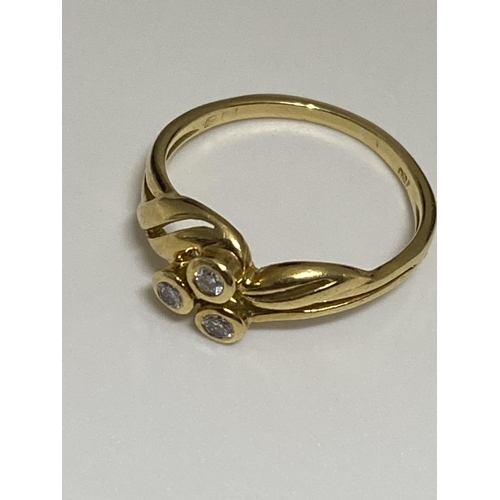 125 - 18ct yellow gold ring with a three singular set diamond design, stamped 750, approx size J