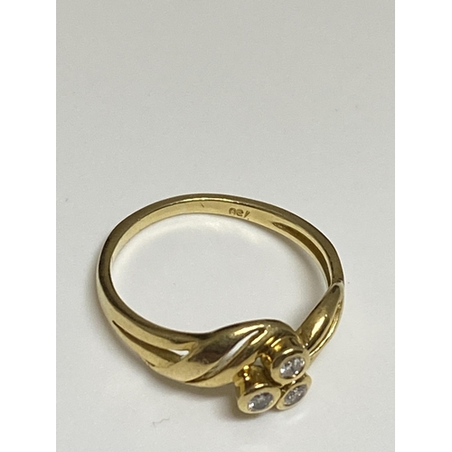 125 - 18ct yellow gold ring with a three singular set diamond design, stamped 750, approx size J