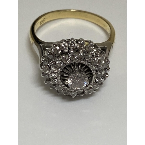 126 - A 18ct gold dress ring, graduating raised mount design with approx .20ct raised central stone with s... 