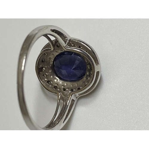 127 - 18ct white gold oval design dress ring with sapphire and diamond surround, approx size O, stamped 18... 