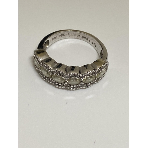 128 - Ladies white gold eternity ring, with central row of oval cut diamonds with smaller chip diamonds to... 