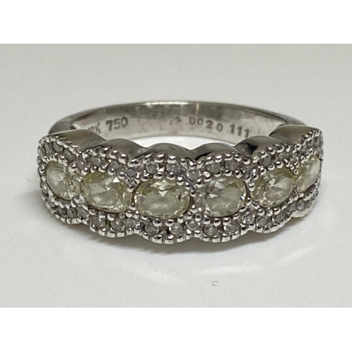 128 - Ladies white gold eternity ring, with central row of oval cut diamonds with smaller chip diamonds to... 