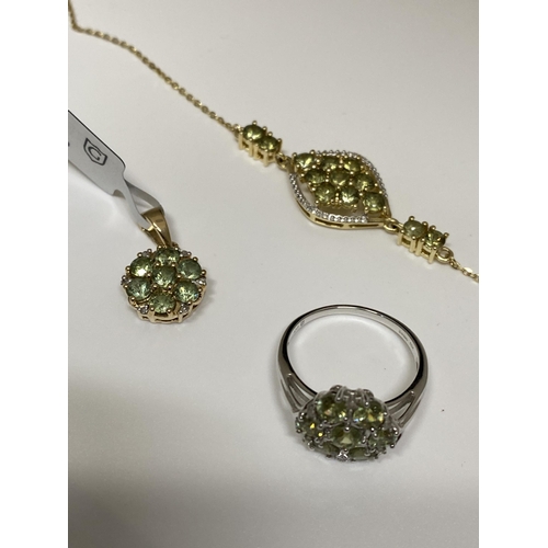 134 - A Peridot 10k yellow gold pendant with matching bracelet marked 10k together with a Peridot white go... 