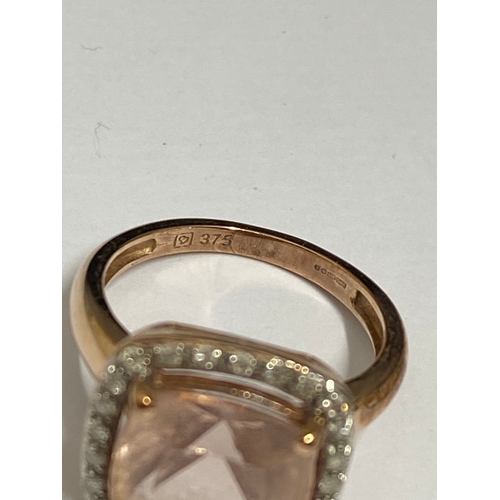 132 - 9ct gold ring with faceted square cut pink central stone with diamond surround marked QVC, approx si... 