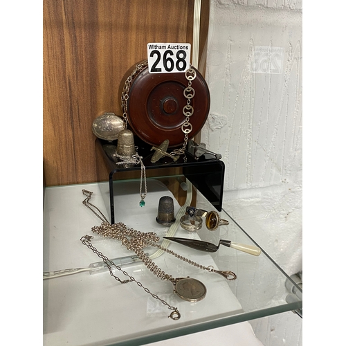 268 - A vintage box containing a selection of silver items including a Scottish pill box, page marker, thi... 