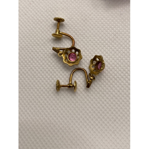 208 - A pair of vintage screw back earrings with pink stone, marked 14ct