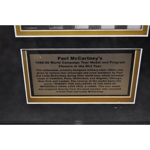 165 - A framed and mounted display of Paul McCartney memorabilia pertaining to his 1989-90 World Campaign ... 