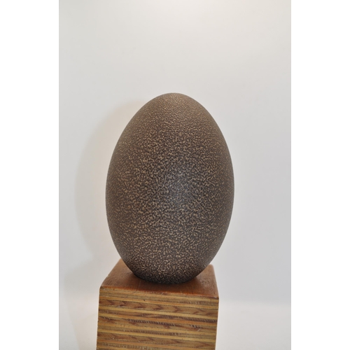 49 - Emu egg with carved kangaroo scene, with a wooden stand