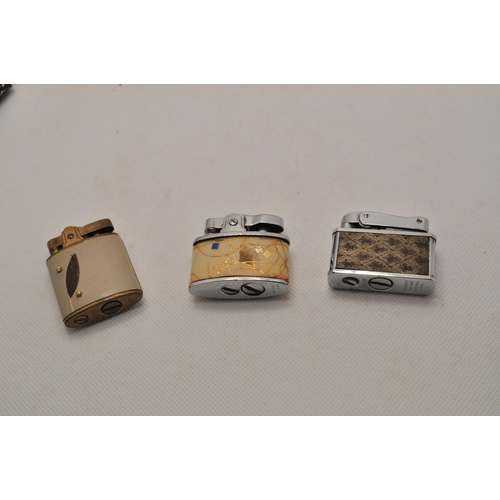 54 - A selection of 10 small lighters, with two sets of four ceramic and glass ashtrays with playing card... 