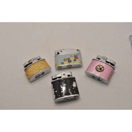 54 - A selection of 10 small lighters, with two sets of four ceramic and glass ashtrays with playing card... 