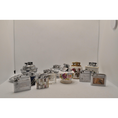 55 - A selection of 11 lighters with various sizes and designs including some tabletop lighters, with a m... 