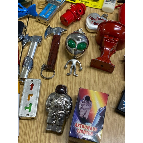 61 - A bundle of novelty lighters in various shapes and designs including an alien, spaceman, mobile phon... 