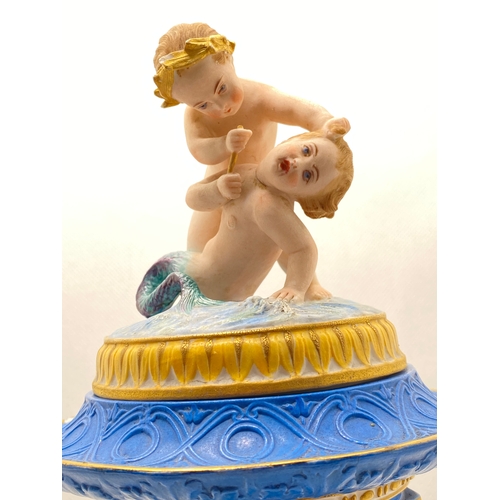 249 - Antique bisque porcelain lidded pedestal vessel featuring playful cherubs/ mélusin by Jean Gille, ma... 