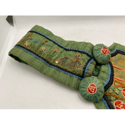 79 - A belle époque-style belt, green dupion silk with an embroidered landscape scene to each panel, repu... 