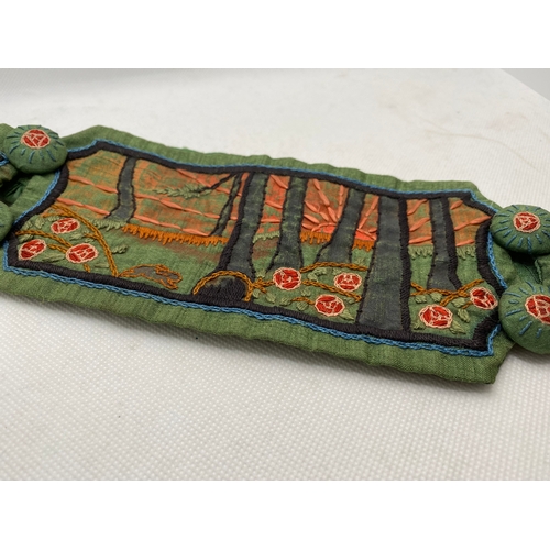 79 - A belle époque-style belt, green dupion silk with an embroidered landscape scene to each panel, repu... 