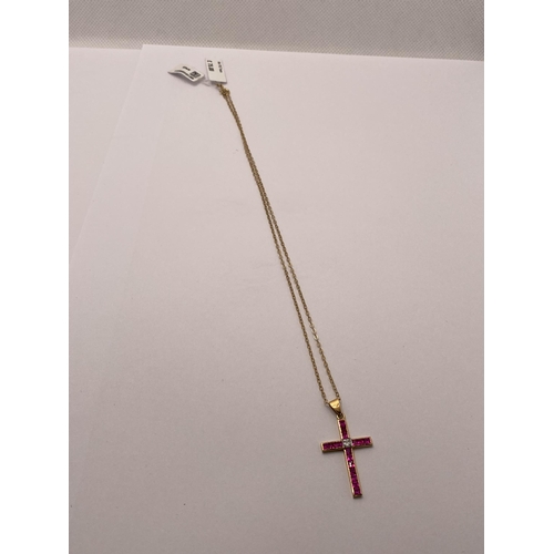 72 - Yellow gold ruby and diamond cross pendant with 9ct yellow gold trace necklace