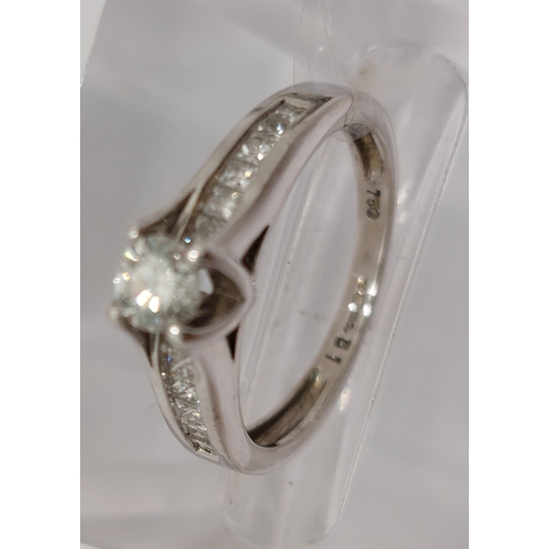 78 - 18ct white gold diamond ring, central round cut stone of approx 0.20ct, with additional x12 princess... 