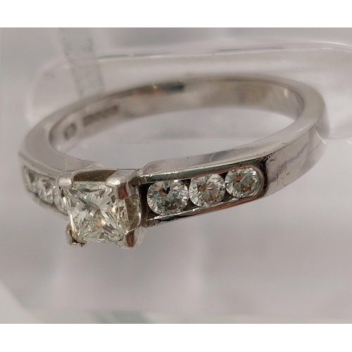 79 - 18ct white gold diamond ring featuring single square cut central stone with round cut stone to mount... 