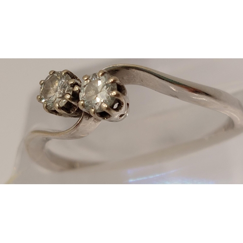 9 - 18ct white gold diamond ring in an interlocking twin stone design, approx 0.30cts, size O/P