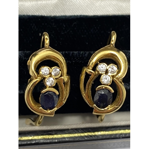 148 - A pair of 14ct yellow gold sapphire and diamond earrings