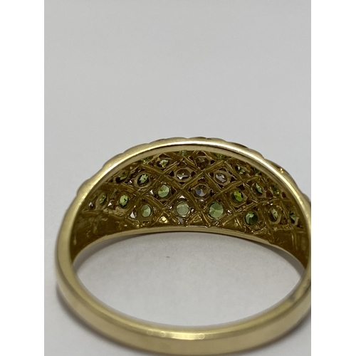 211 - Yellow gold peridot and diamond cluster ring, stamped 14k, approx size X/Y