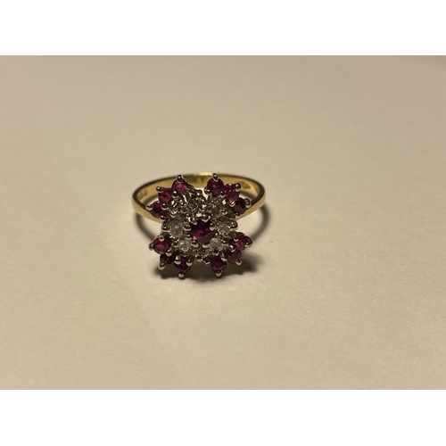 218 - An 18ct yellow gold ruby and diamond cluster ring, approx size O, stamped 750